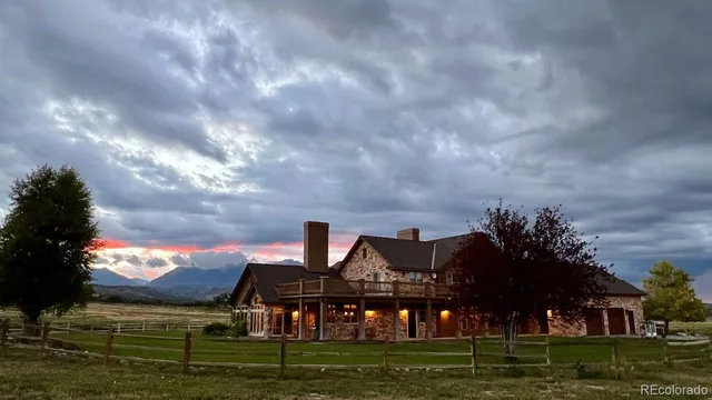 a view of house with outdoor space and lake view