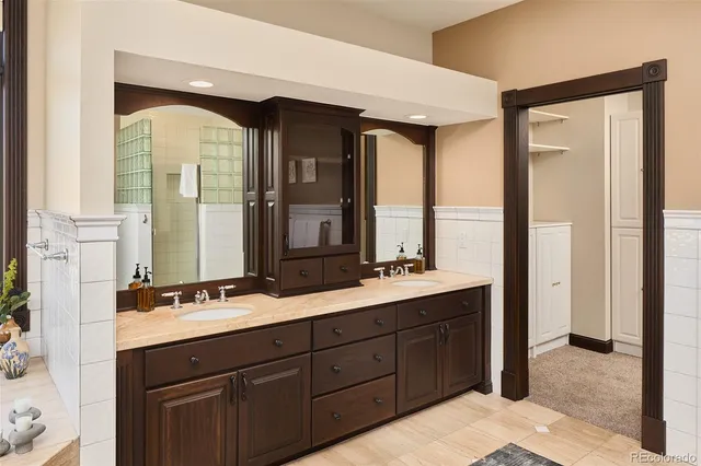 a spacious bathroom with a double vanity sink and a mirror