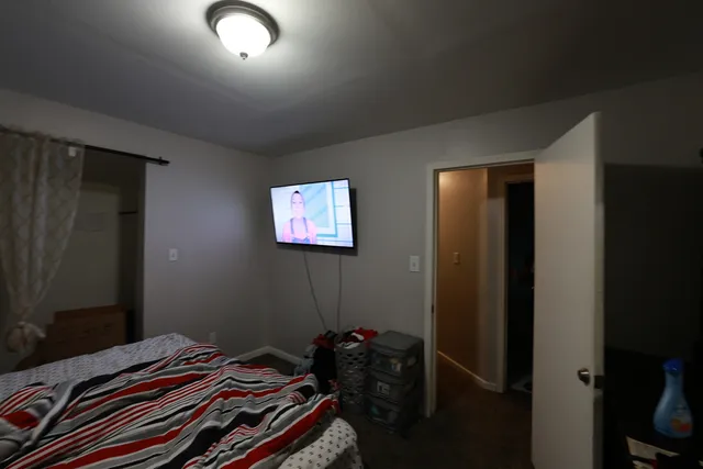 a bedroom with a bed and a dresser