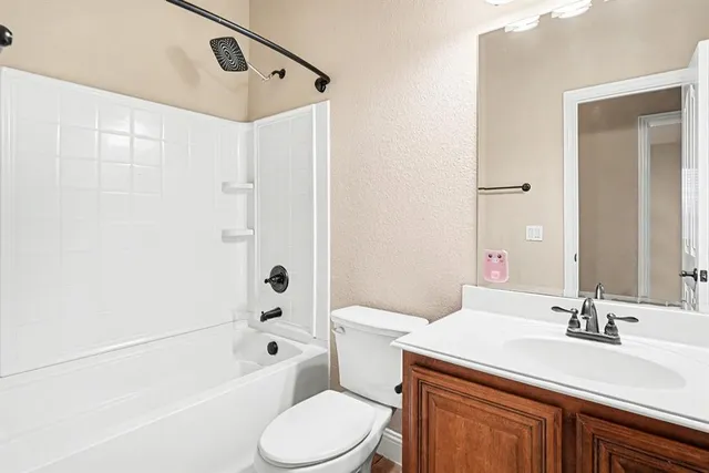 a bathroom with a sink toilet vanity and shower