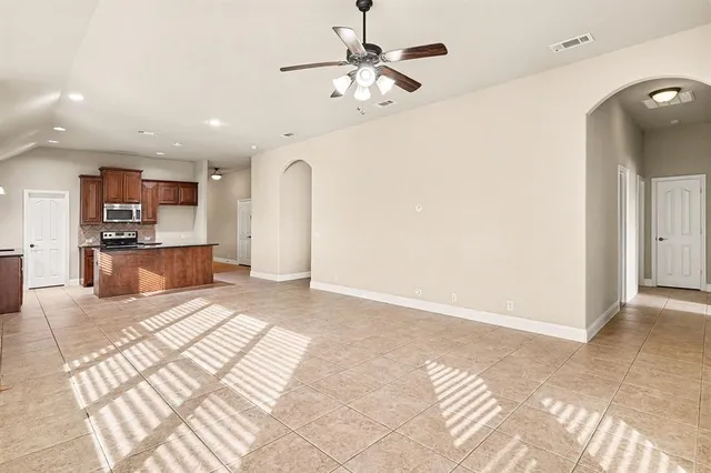 a spacious bathroom with a granite countertop sink a mirror and a shower
