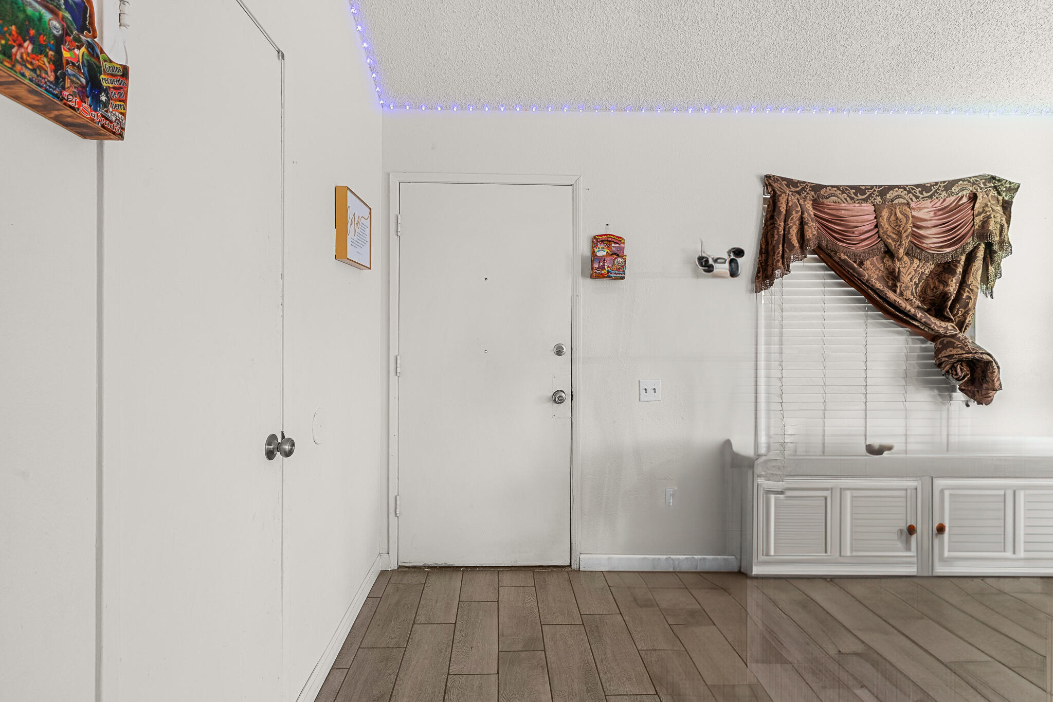 45546 Aladdin Street, Unit A101 Indio, CA 92201 - Photo 13 of 22 a view of a livingroom with an empty space and wooden floor