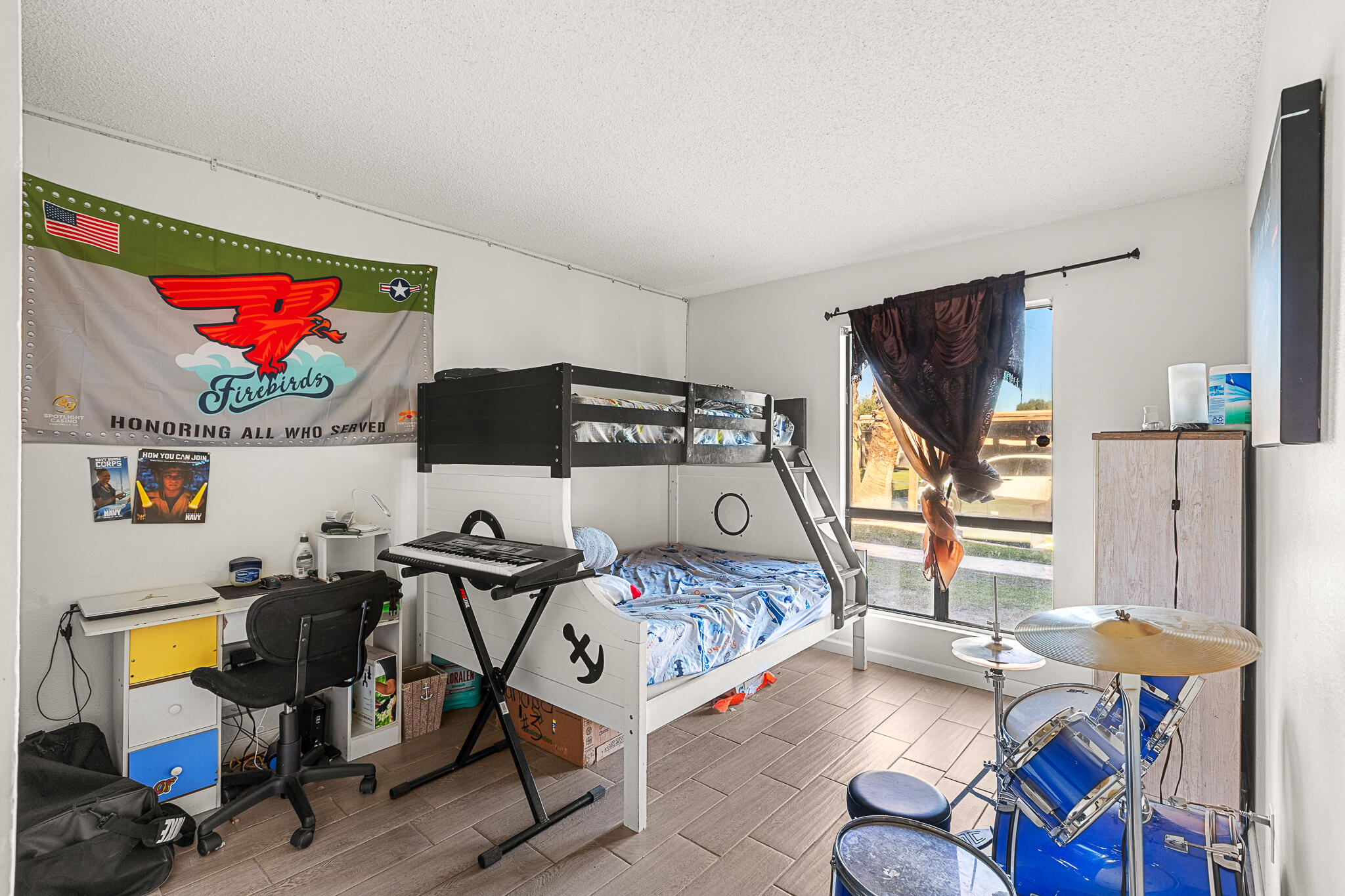 45546 Aladdin Street, Unit A101 Indio, CA 92201 - Photo 18 of 22 a bedroom with furniture and a flat screen tv