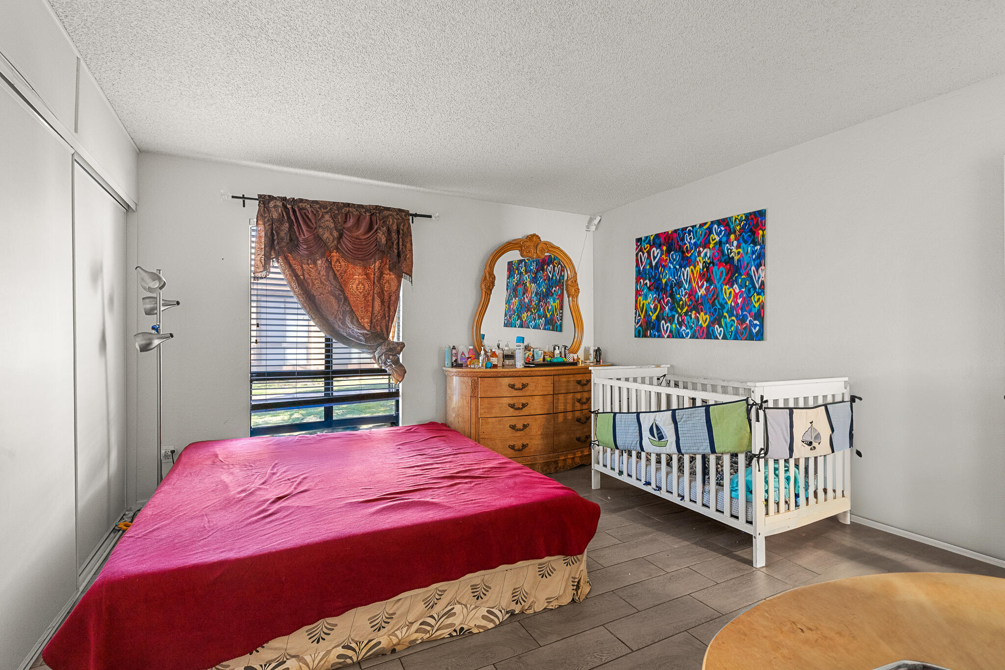 45546 Aladdin Street, Unit A101 Indio, CA 92201 - Photo 20 of 22 a bedroom with a bed a rug and a painting on the wall