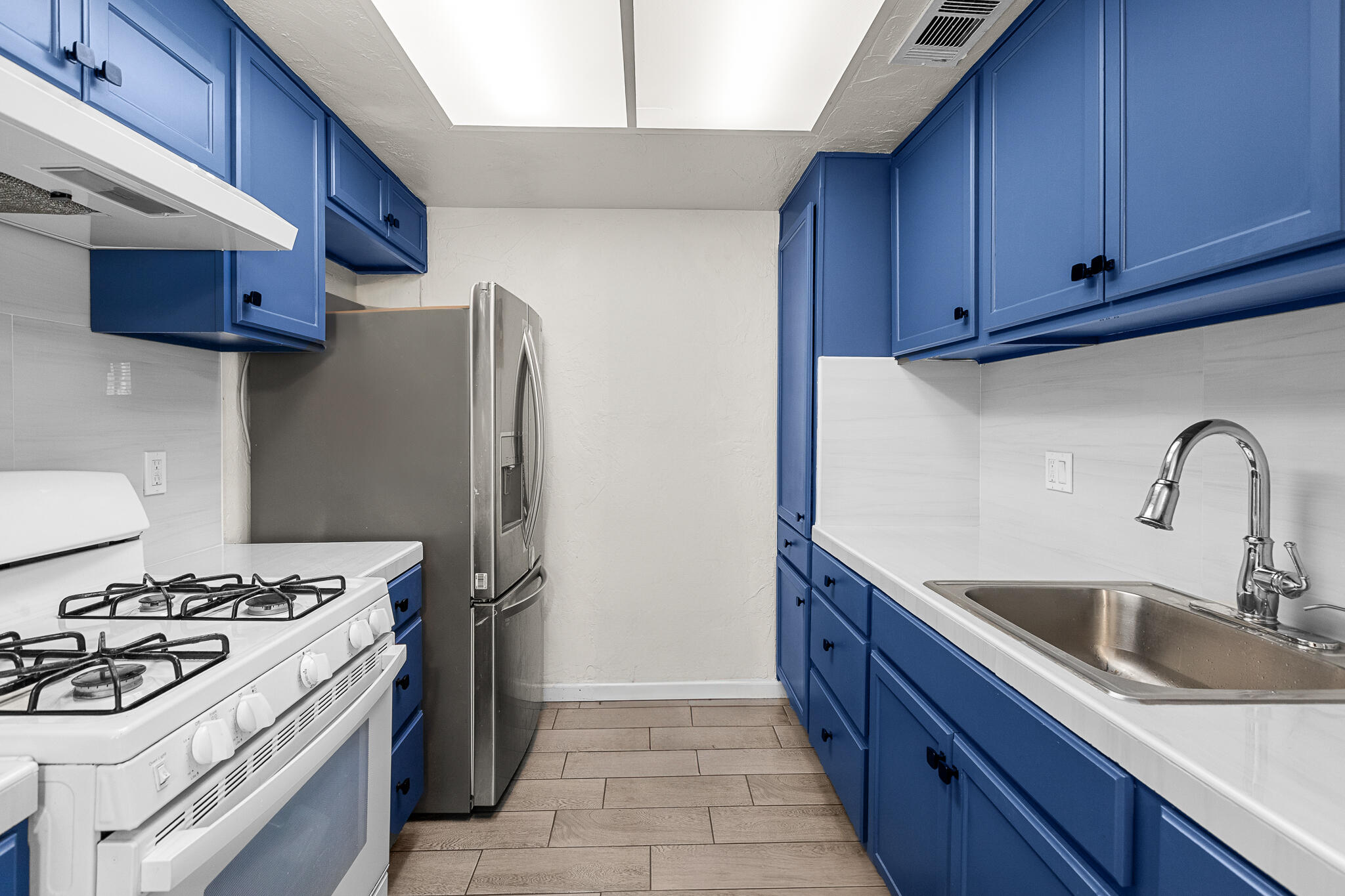 45546 Aladdin Street, Unit A101 Indio, CA 92201 - Photo 2 of 22 a kitchen with stainless steel appliances granite countertop a sink stove and refrigerator