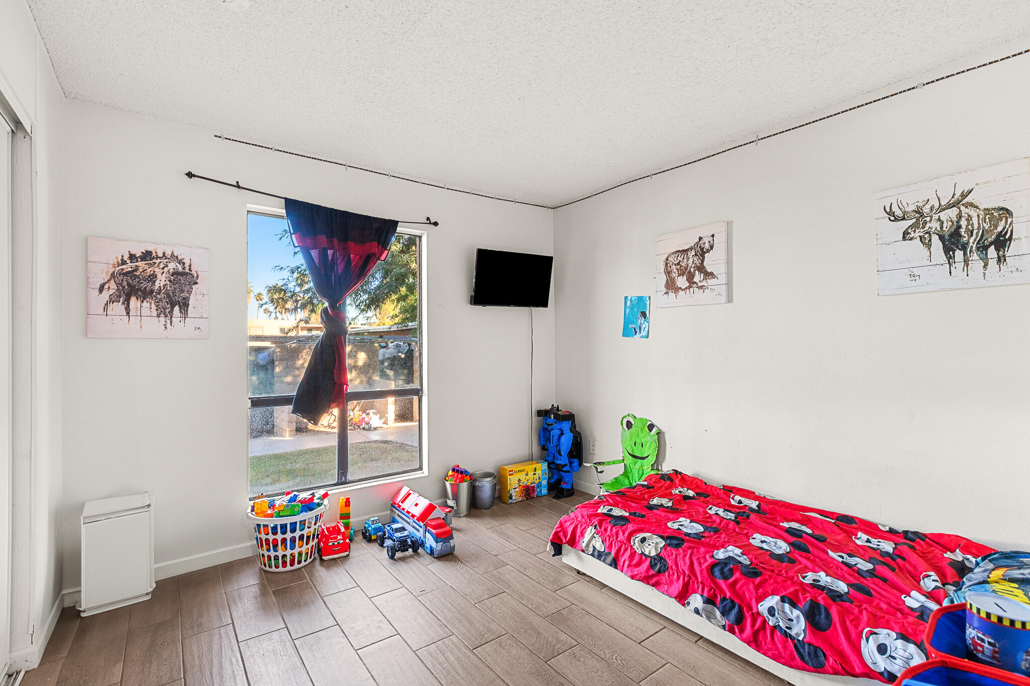 45546 Aladdin Street, Unit A101 Indio, CA 92201 - Photo 21 of 22 a bedroom with toys and a wooden floor