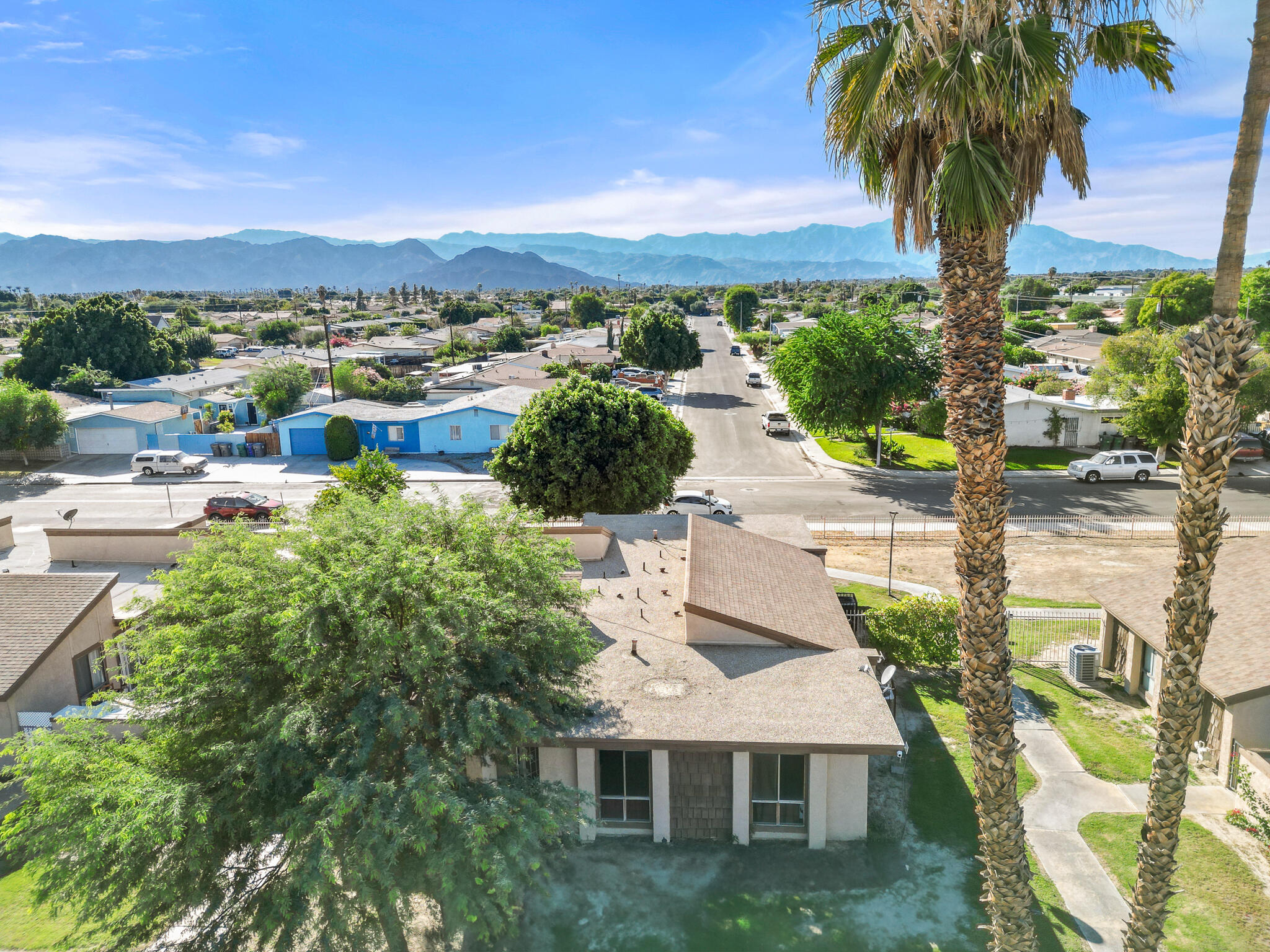 45546 Aladdin Street, Unit A101 Indio, CA 92201 - Photo 8 of 22 a view of a house with a yard and balcony
