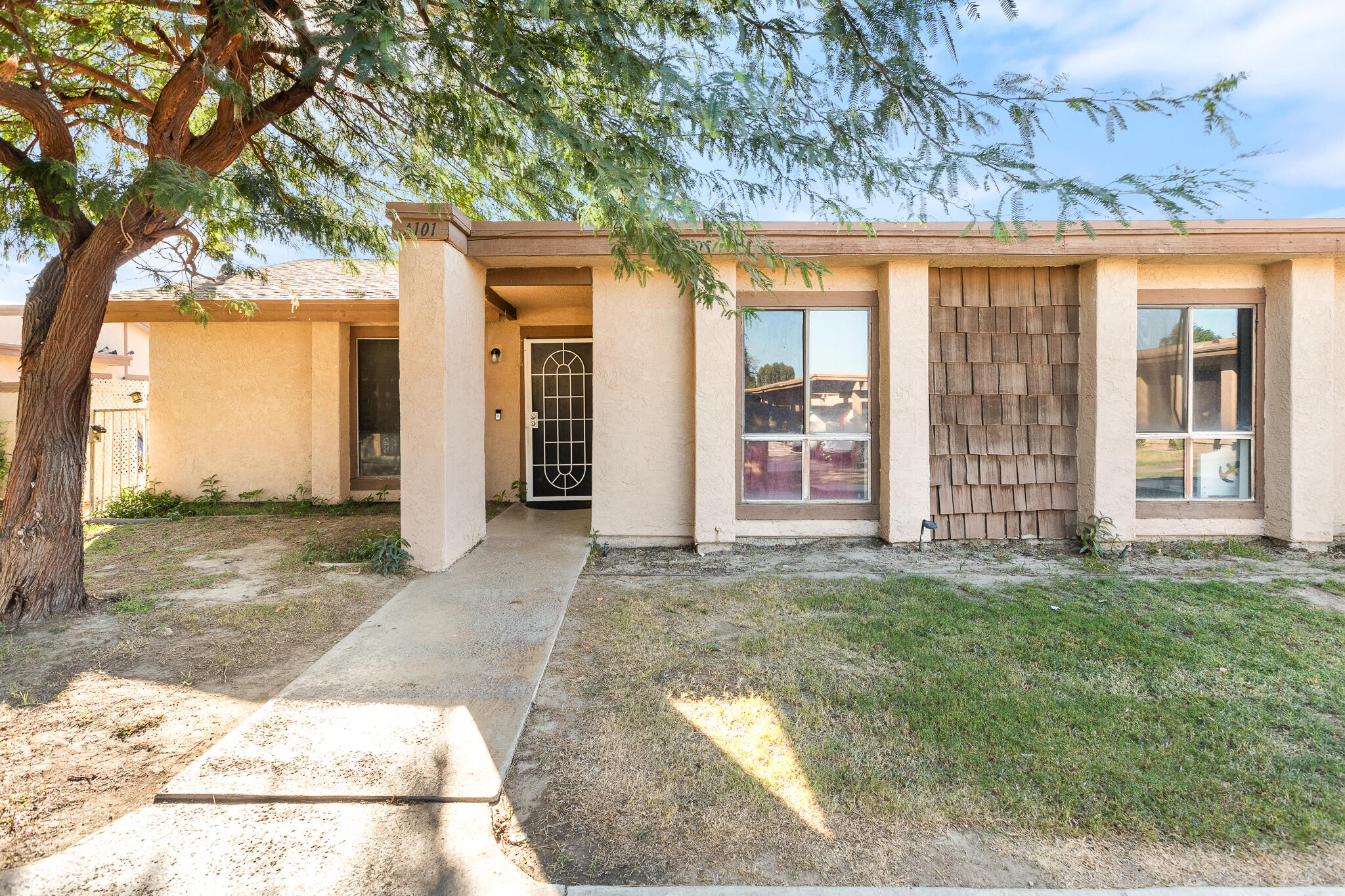 45546 Aladdin Street, Unit A101 Indio, CA 92201 - Photo 10 of 22 a view of a house with a yard