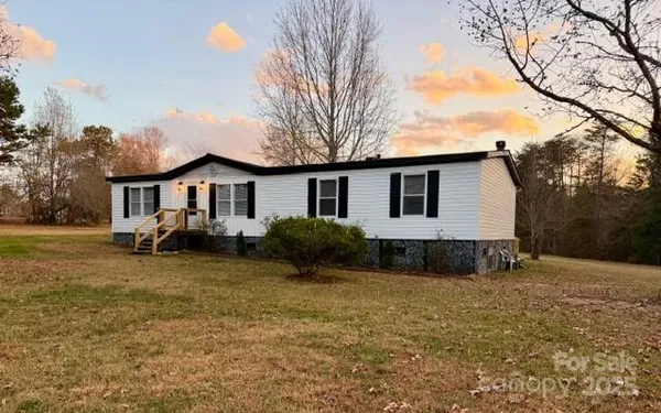 a view of a house with a yard covered in snow