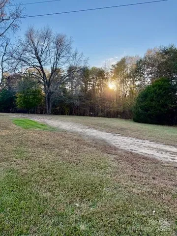 a view of a field with trees in the background