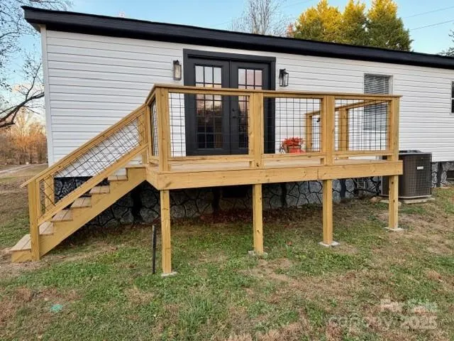 a house with large window and wooden fence
