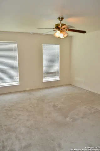 a view of a livingroom with a chandelier fan and a chandelier