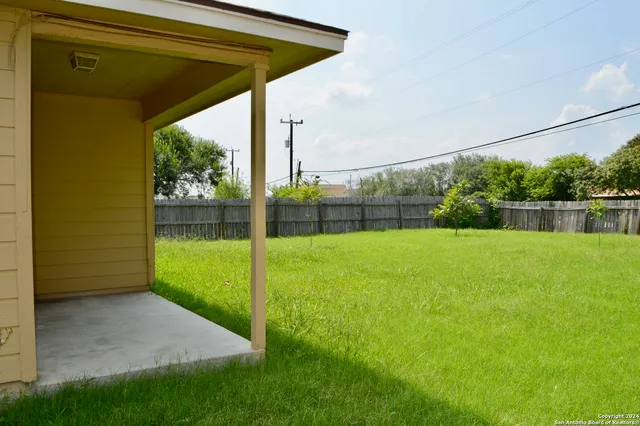 a view of a backyard with grass