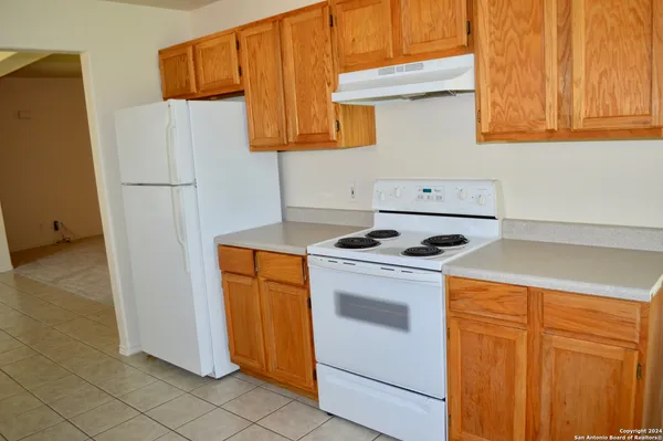 a kitchen with stainless steel appliances white cabinets and a refrigerator