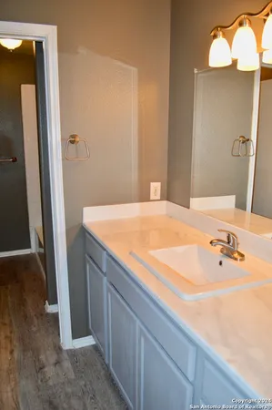 a bathroom with a tub sink and vanity