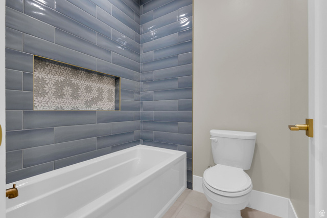 2828 Jojo Road Eagle Mountain, UT 84005 - Photo 32 of 63 Bathtub with blue subway tile surround featuring a decorative mosaic niche