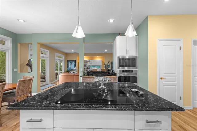 a kitchen with stainless steel appliances granite countertop a stove and a microwave