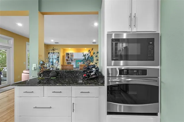 a living room with furniture a wooden floor and next to a window