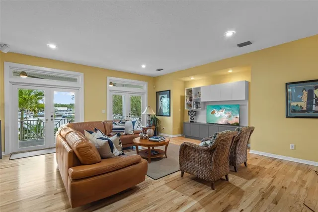 a living room with lots of furniture and wooden floor
