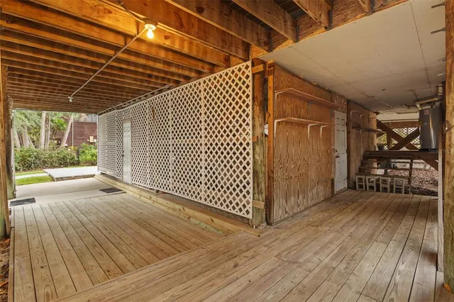 a view of a balcony with wooden floor and fence