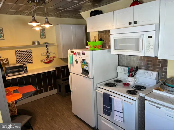 a kitchen with a stove and a refrigerator