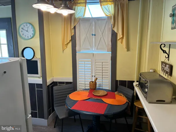 a dining room with furniture and window
