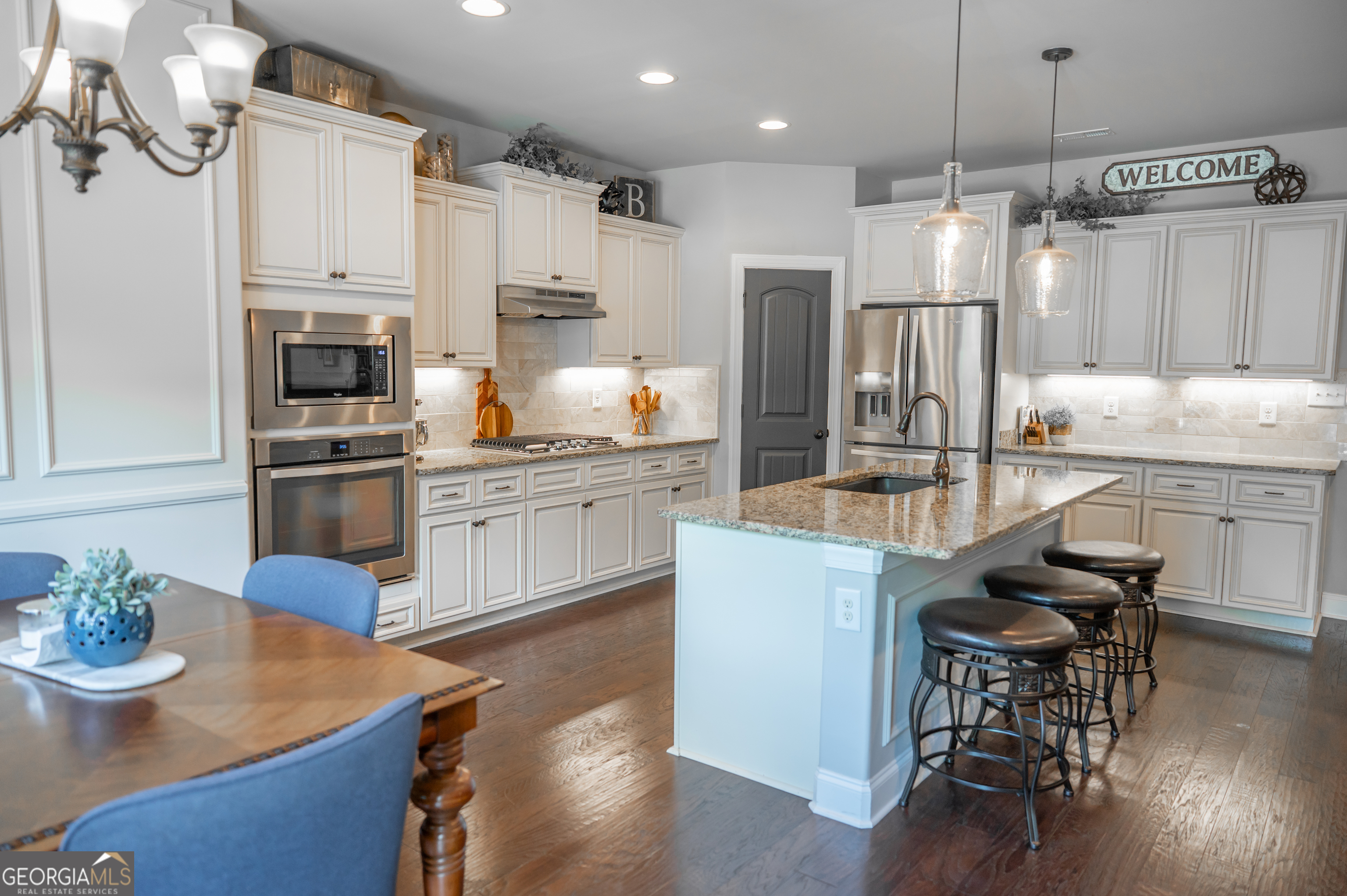 415 EAS Way Fayetteville, GA 30215 - Photo 11 of 70 a kitchen with kitchen island a stove a table and chairs in it