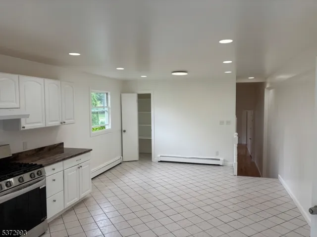 a view of a kitchen with an empty space and a window