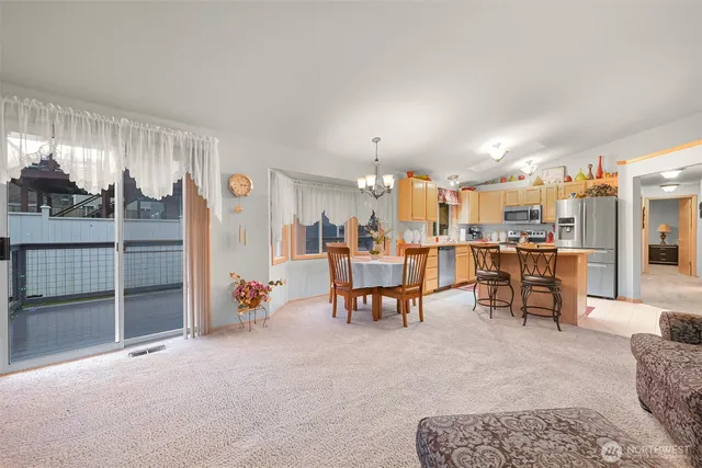 a living room with lots of furniture and a kitchen