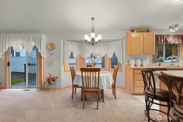 a view of a dining room with furniture and chandelier