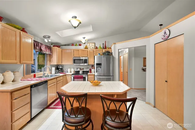 a kitchen with a dining table and chairs