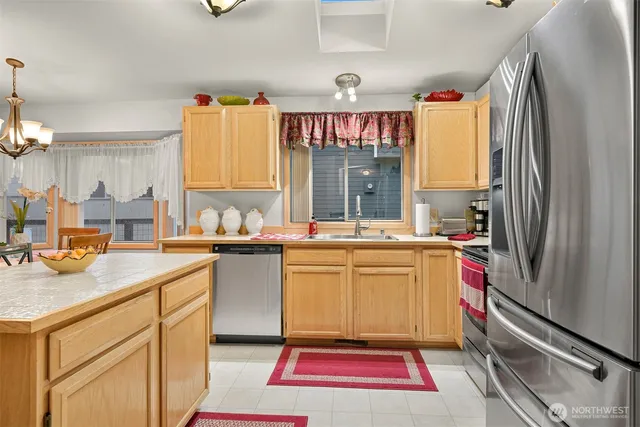 a kitchen with a refrigerator and a sink