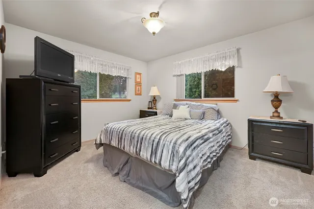 a bedroom with a bed and a tv