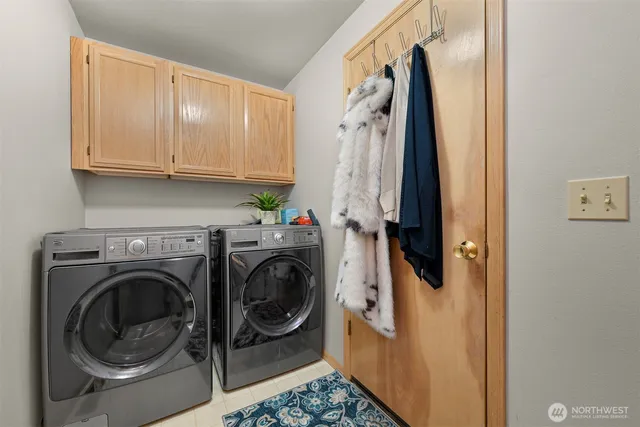 a view of a storage and utility room with washer and dryer