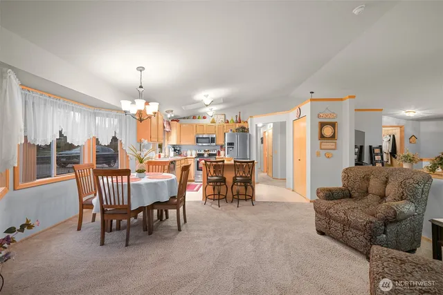 a living room with furniture and a dining table