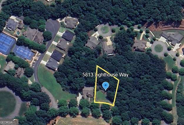 an aerial view of a house with garden space and street view