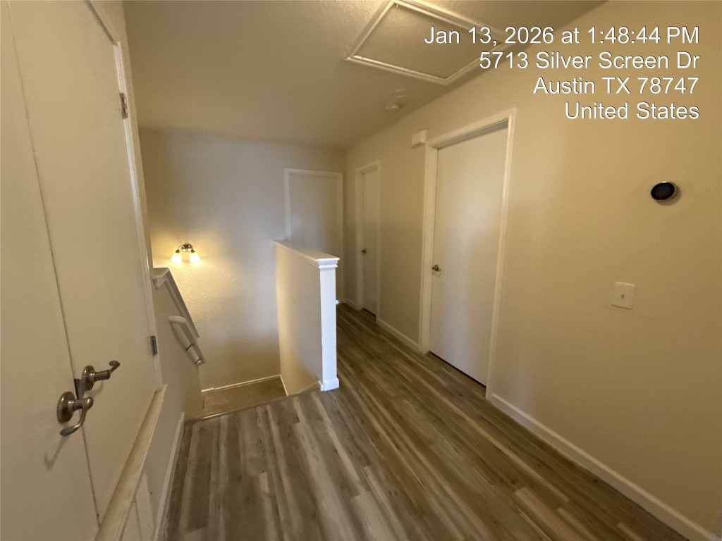 5713 Silver Screen Drive Austin, TX 78747 - Photo 12 of 21 Corridor with an upstairs landing and dark wood-style floors
