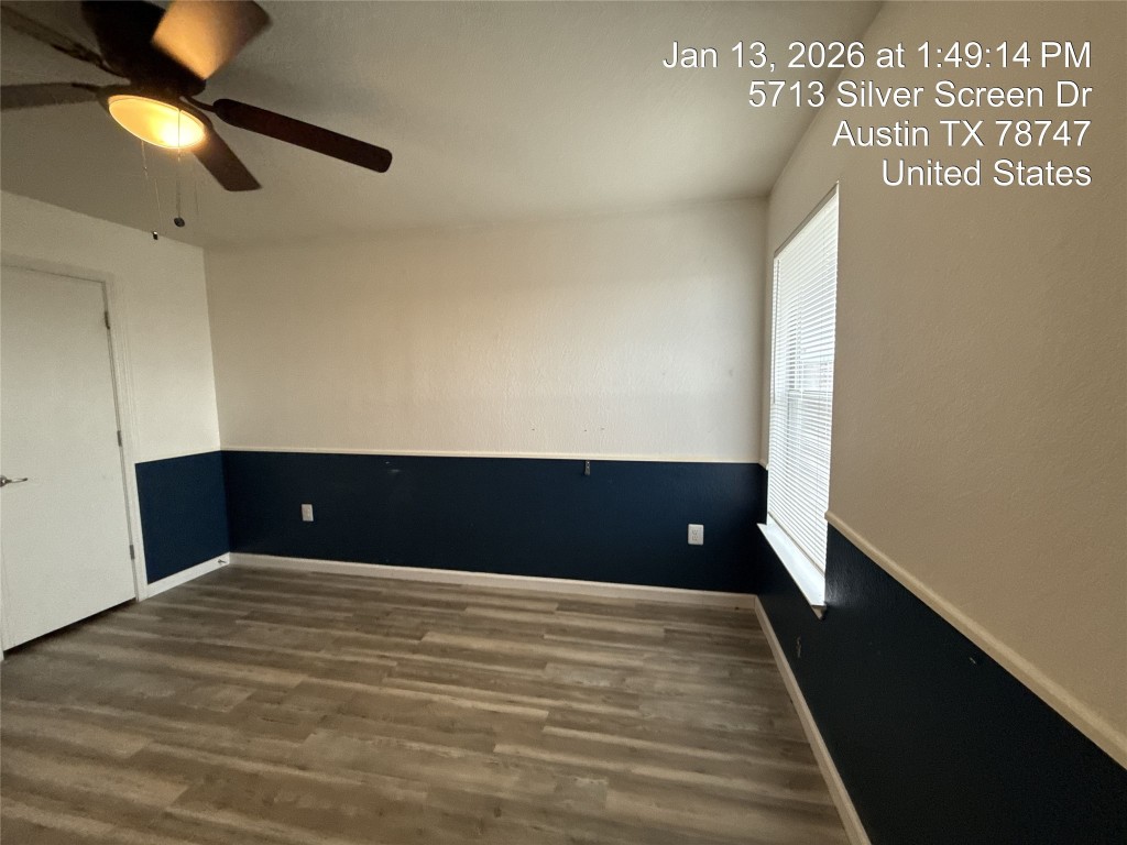 5713 Silver Screen Drive Austin, TX 78747 - Photo 14 of 21 Unfurnished room with dark wood-style floors and a ceiling fan