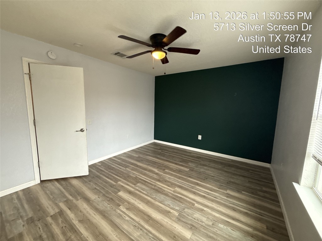 5713 Silver Screen Drive Austin, TX 78747 - Photo 16 of 21 Unfurnished bedroom with wood finished floors and ceiling fan