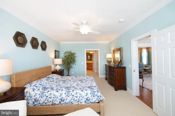 a bedroom with a large bed and a chandelier