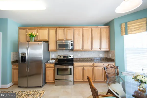 a kitchen with a stove a sink and appliances