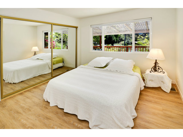 552 Bean Creek Road, Unit 88 Scotts Valley, CA 95066 - Photo 14 of 25 a bedroom with a bed and wooden floor