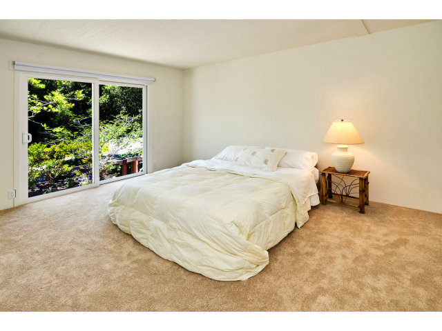 552 Bean Creek Road, Unit 88 Scotts Valley, CA 95066 - Photo 16 of 25 a bed sitting in a bedroom next to a window