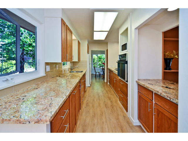 552 Bean Creek Road, Unit 88 Scotts Valley, CA 95066 - Photo 7 of 25 a open kitchen with kitchen island granite countertop wooden floor a large window and stainless steel appliances