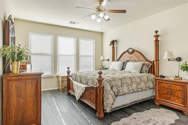 a bedroom with a large bed and a chandelier
