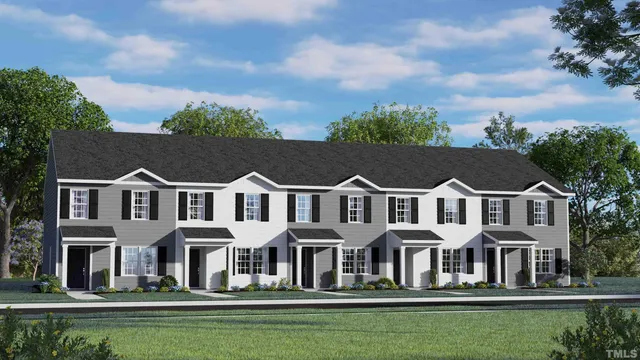 a front view of a house with a garden and trees