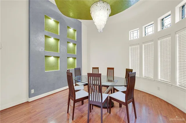 a view of a dining room with furniture and chandelier