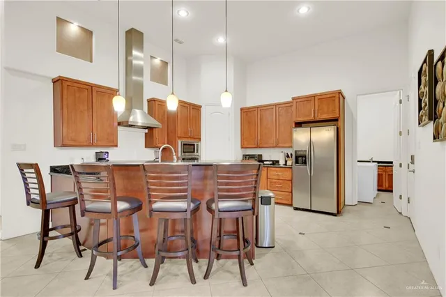 a kitchen with a table chairs refrigerator and microwave