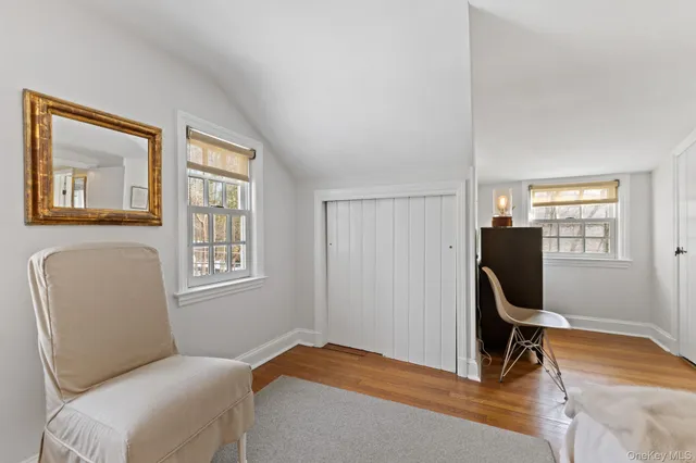 a bedroom with a bed chair and window