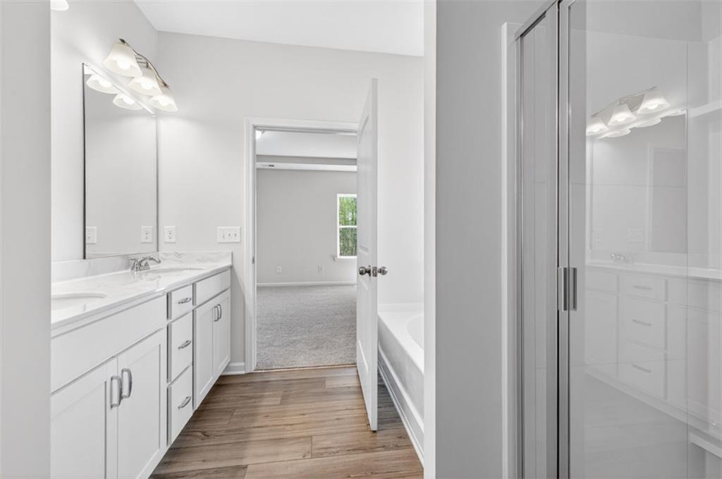 704 Sinclair Lane Temple, GA 30179 - Photo 22 of 37 a bathroom with a double vanity sink and a mirror
